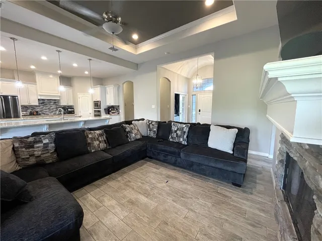 a large living room with a couch and a fireplace