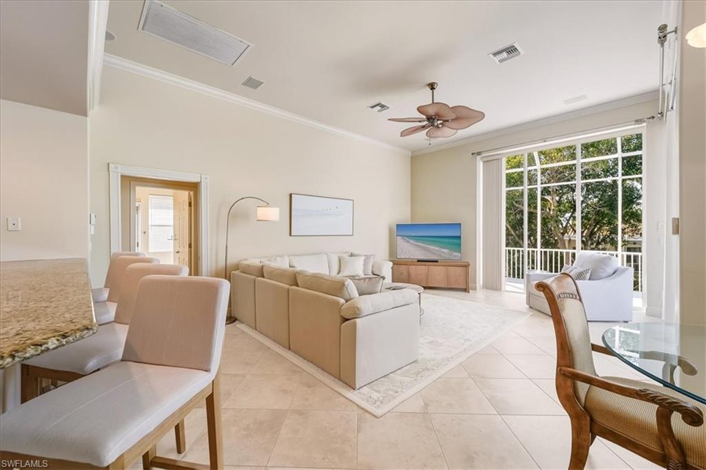 560 Inlet Drive Marco Island, FL 34145 - Photo 11 of 32 Living room featuring ornamental molding, light tile patterned floors, ceiling fan, and healthy amount of natural light