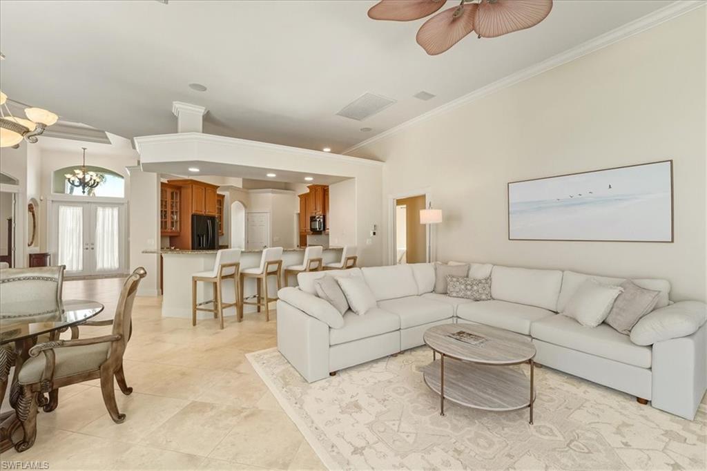560 Inlet Drive Marco Island, FL 34145 - Photo 12 of 32 Living room featuring crown molding, arched walkways, a chandelier, french doors, and ceiling fan