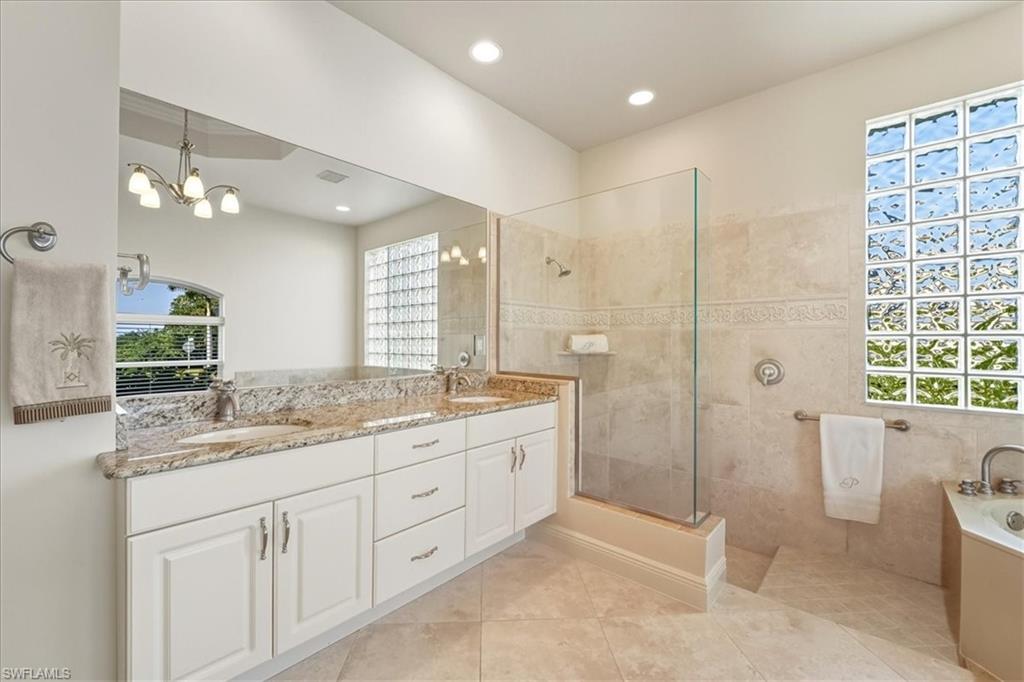 560 Inlet Drive Marco Island, FL 34145 - Photo 20 of 32 Full bath featuring double vanity, a garden tub, a walk in shower, light tile patterned floors, and recessed lighting