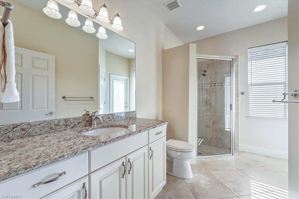 560 Inlet Drive Marco Island, FL 34145 - Photo 22 of 32 Full bathroom with vanity, a shower stall, light tile patterned floors, and recessed lighting