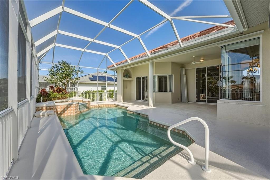 560 Inlet Drive Marco Island, FL 34145 - Photo 24 of 32 View of pool with a sunroom, a patio, a lanai, and a pool with connected hot tub