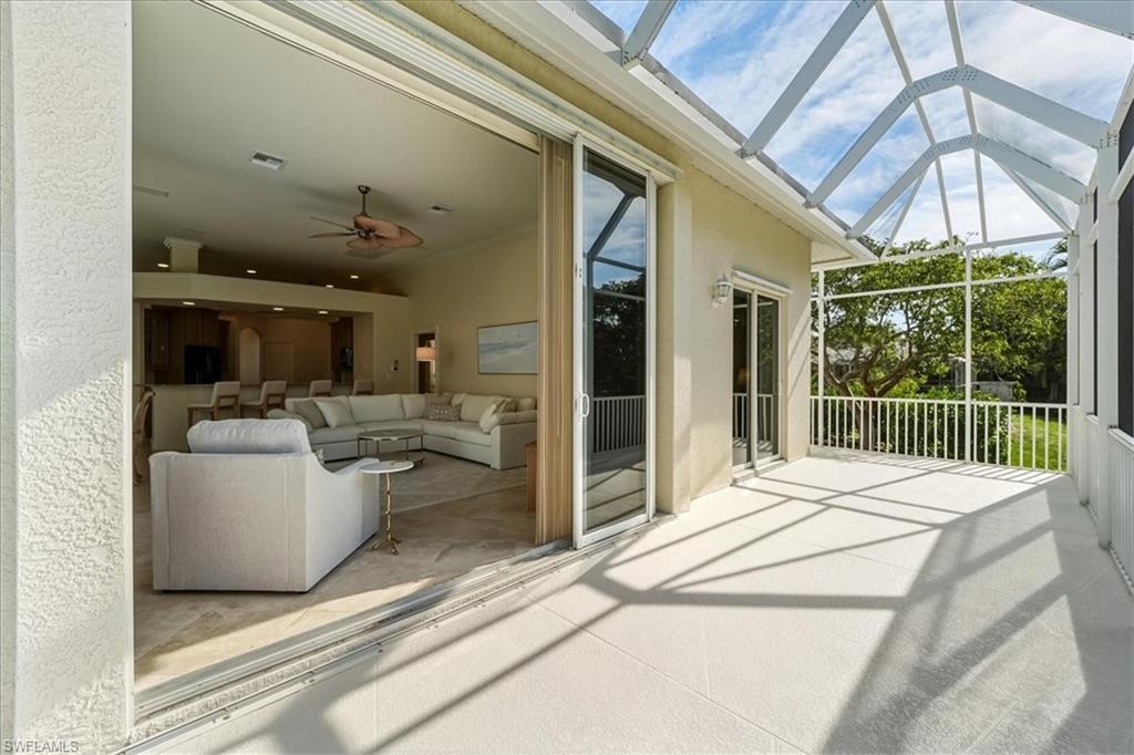 560 Inlet Drive Marco Island, FL 34145 - Photo 25 of 32 Sunroom featuring a patio, ceiling fan, and outdoor lounge area