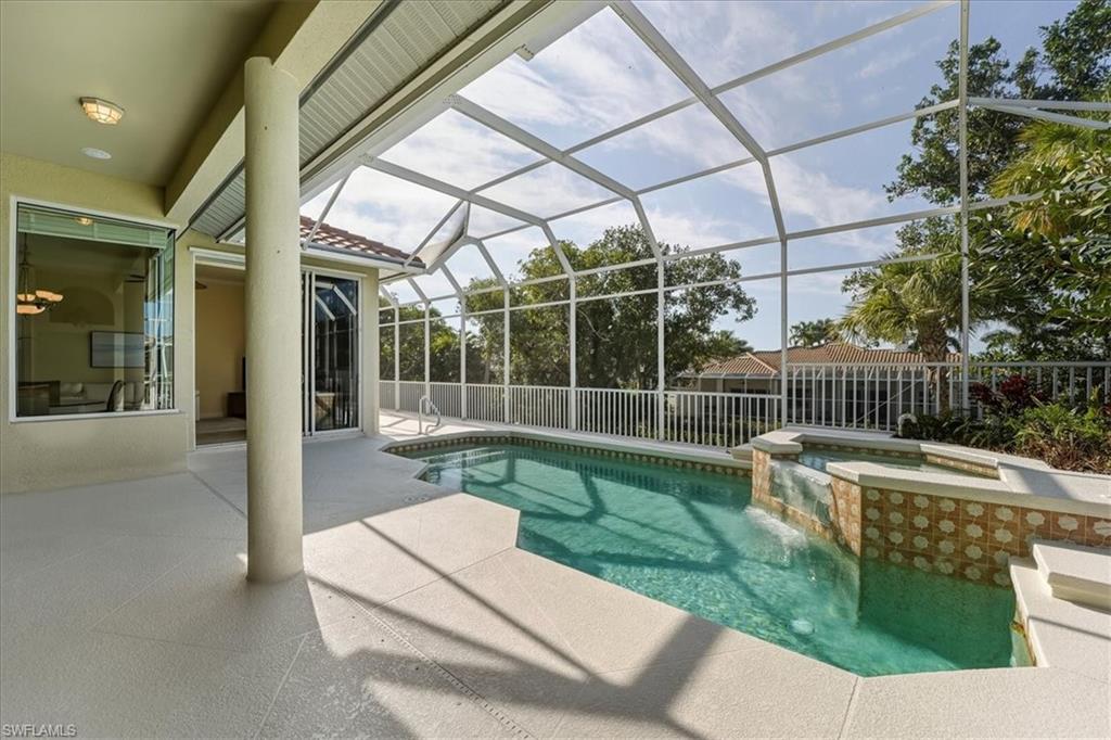 560 Inlet Drive Marco Island, FL 34145 - Photo 4 of 32 View of pool with a patio area, a lanai, a sunroom, and a pool with connected hot tub