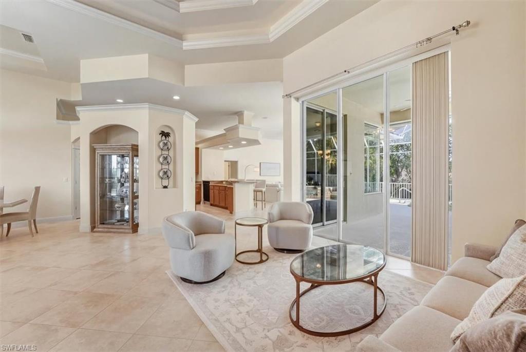 560 Inlet Drive Marco Island, FL 34145 - Photo 9 of 32 Living area with a raised ceiling, arched walkways, and crown molding