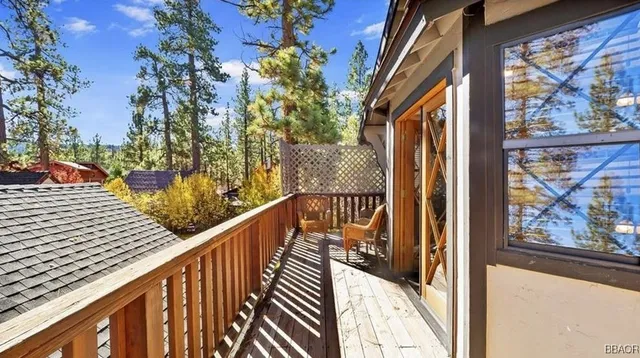 a view of balcony with wooden floor and fence