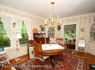 1122 Springfield Avenue New Providence, NJ 07974 - Photo 11 of 28 a living room with furniture a chandelier and a table
