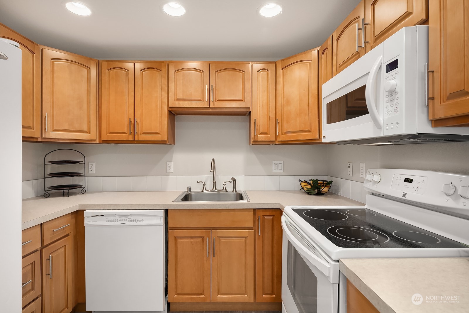 3625 Northeast 7th Place Renton, WA 98056 - Photo 11 of 23 a kitchen with stainless steel appliances granite countertop a sink stove and cabinets