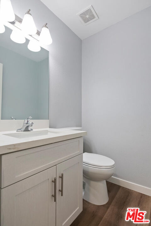 29239 Heathercliff Road, Unit 12 Malibu, CA 90265 - Photo 30 of 32 a bathroom with a toilet sink and mirror