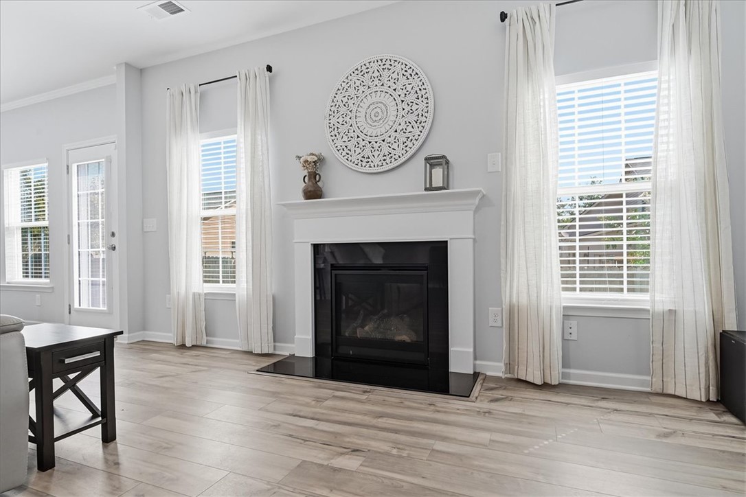 208 Grassy Creek Way Pendleton, SC 29670 - Photo 17 of 43 A refined fireplace and mantle serve as the focal point of this bright living area, offering a cozy ambiance.