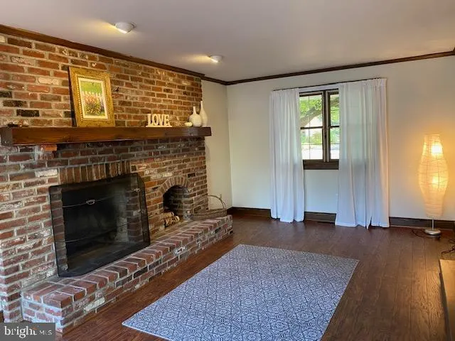 a living room with furniture wooden floor and a fireplace