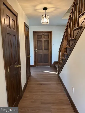 a view of entryway and hall with wooden floor
