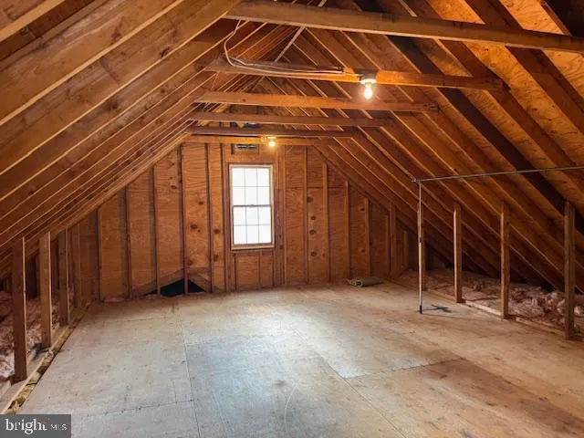 a view of an empty room with wooden walls