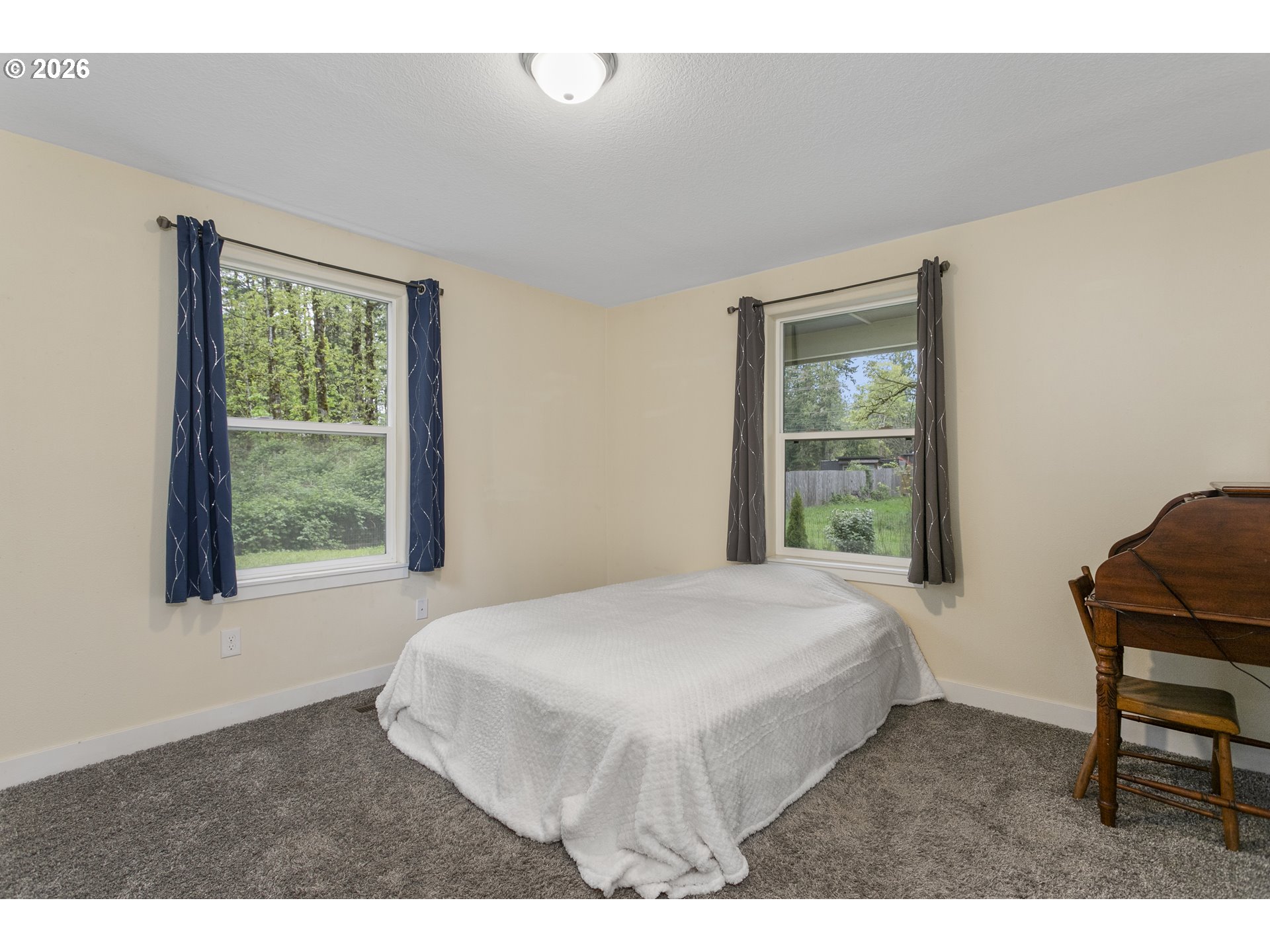 23575 East Gumjuwac Road Welches, OR 97067 - Photo 12 of 48 a bedroom with a bed window and a chair