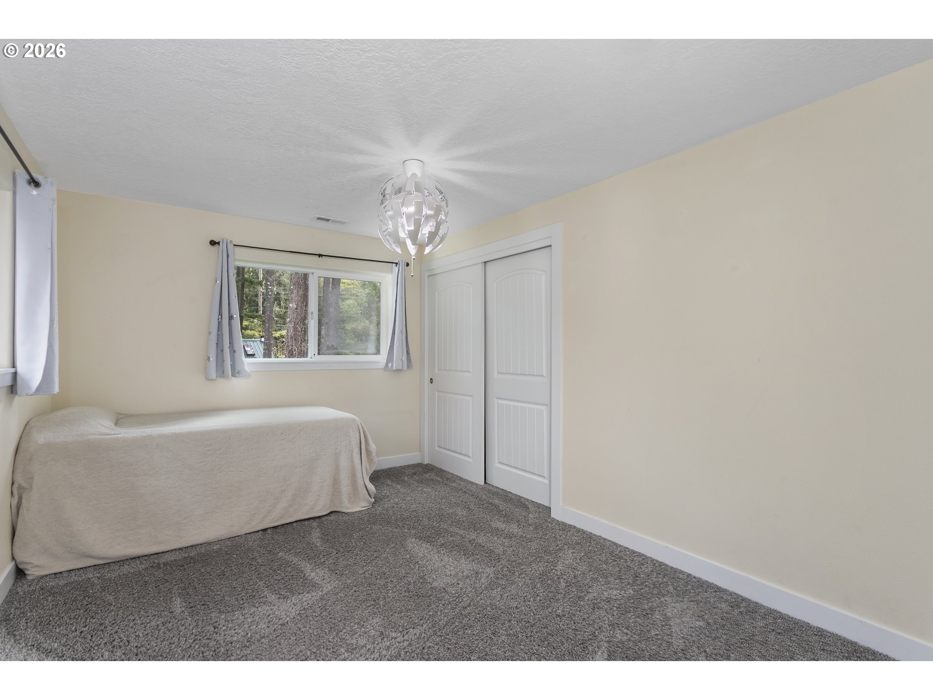 23575 East Gumjuwac Road Welches, OR 97067 - Photo 23 of 48 a spacious bedroom with a bed and a window