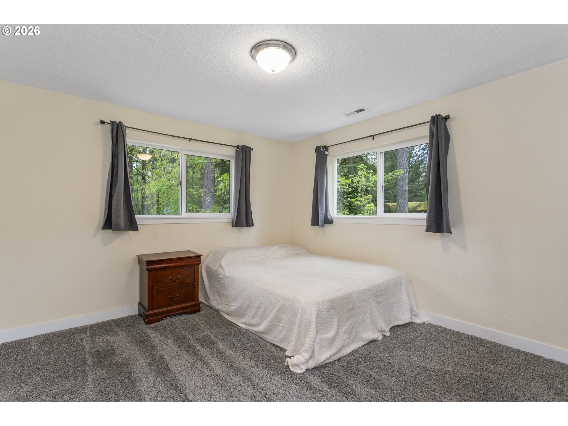 23575 East Gumjuwac Road Welches, OR 97067 - Photo 28 of 48 a bedroom with a bed window and a dresser