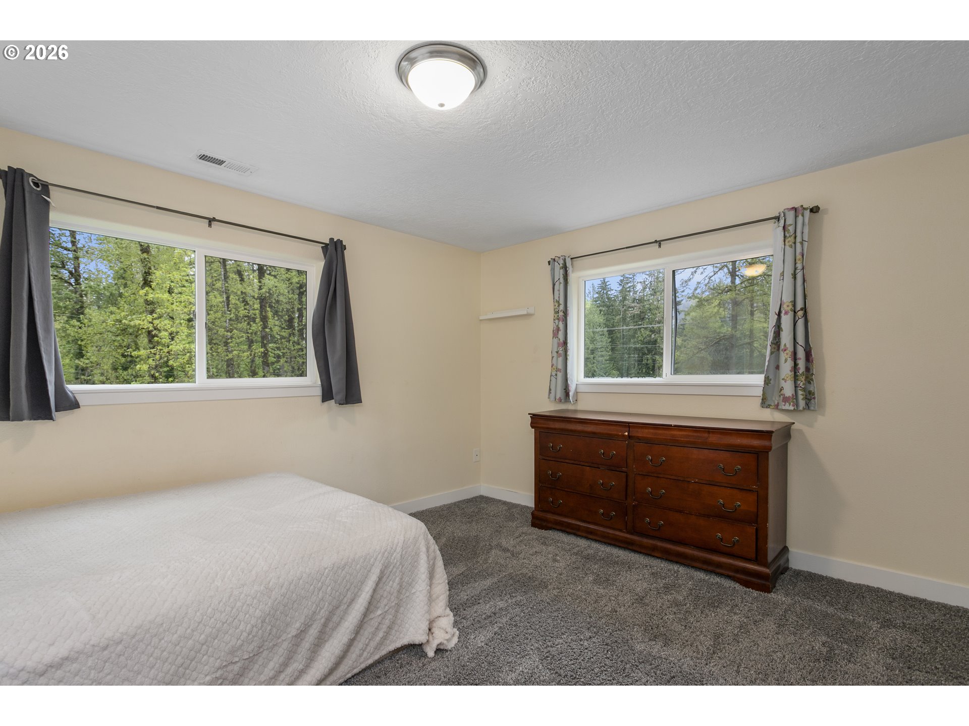 23575 East Gumjuwac Road Welches, OR 97067 - Photo 29 of 48 a bedroom with a bed and a window