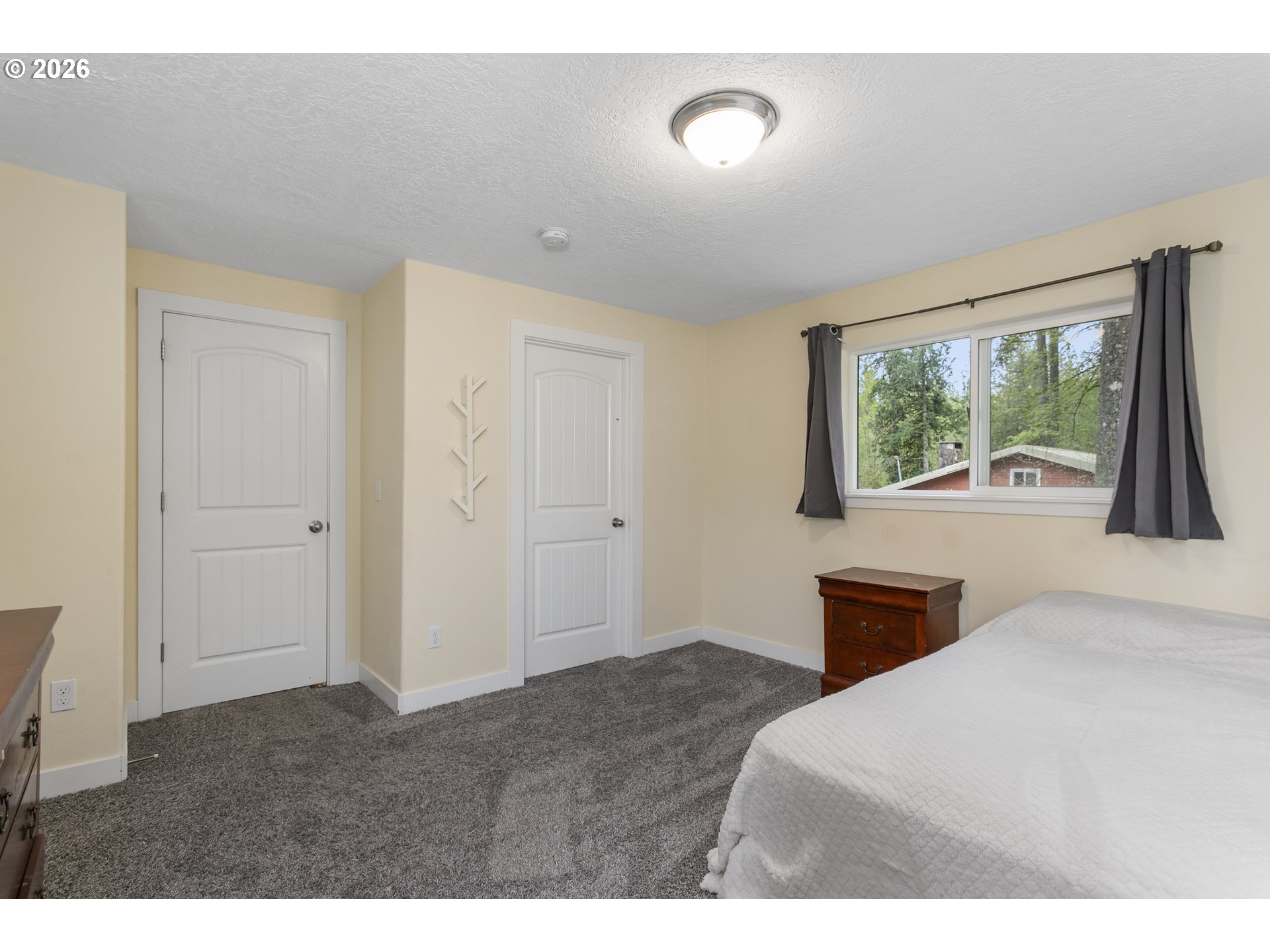 23575 East Gumjuwac Road Welches, OR 97067 - Photo 30 of 48 a bedroom with a bed and a large window