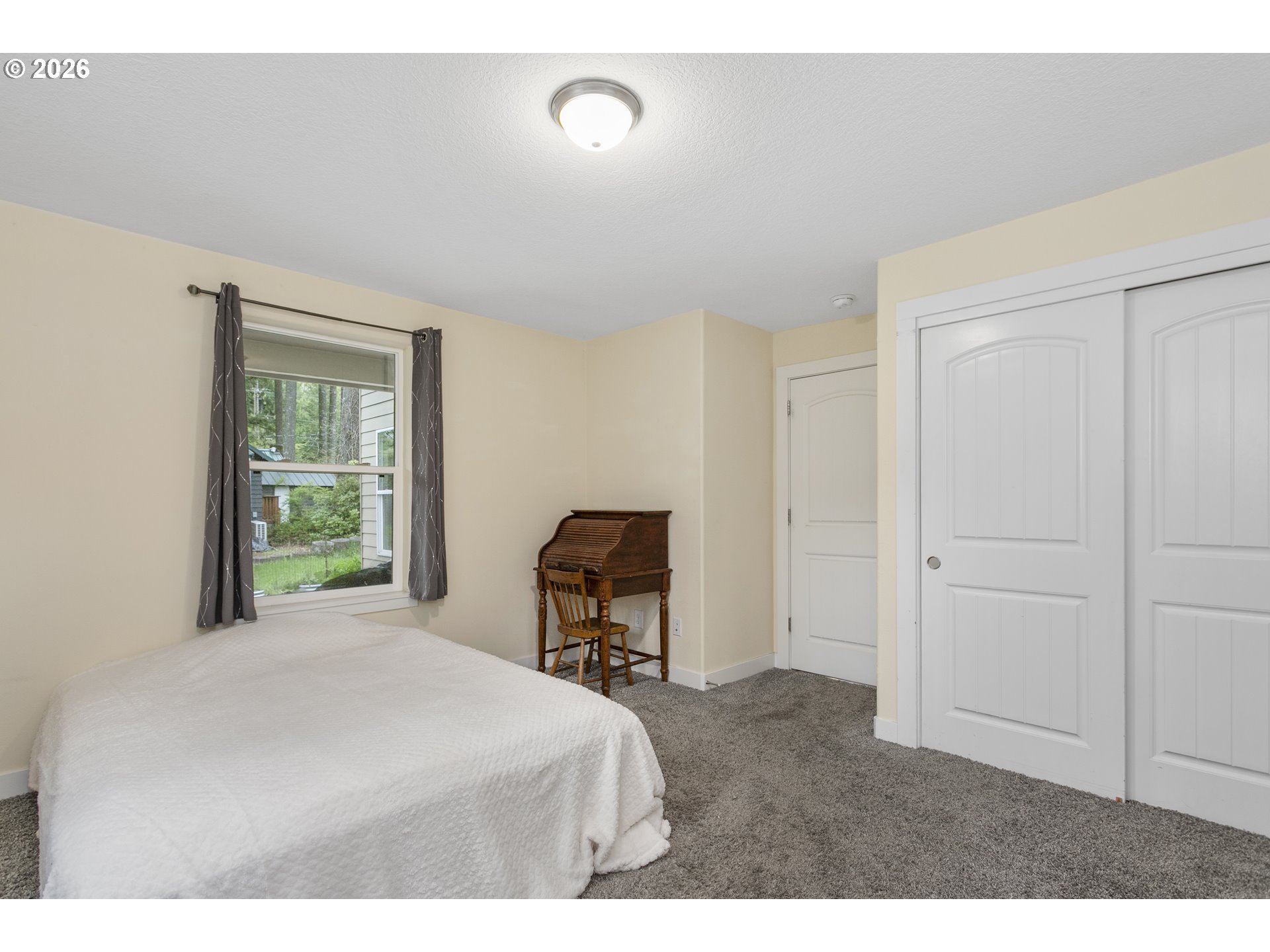 23575 East Gumjuwac Road Welches, OR 97067 - Photo 32 of 48 a bedroom with a bed and a chair