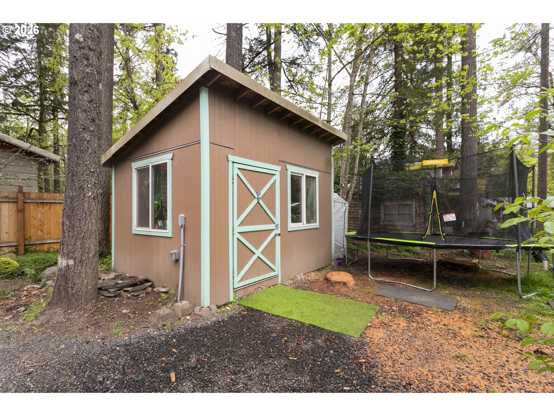 23575 East Gumjuwac Road Welches, OR 97067 - Photo 33 of 48 a backyard of a house with wooden fence and a bench