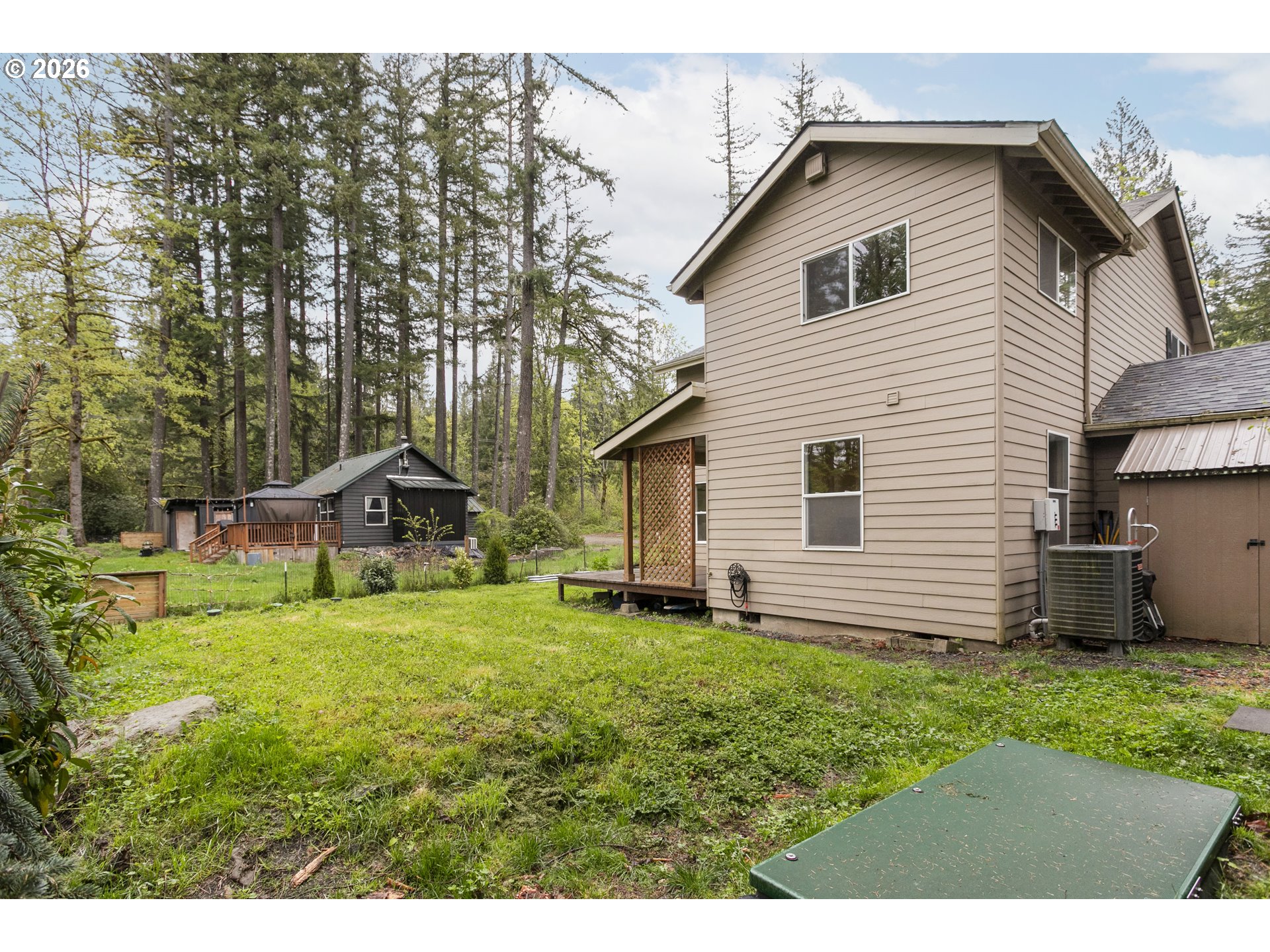 23575 East Gumjuwac Road Welches, OR 97067 - Photo 36 of 48 a backyard of a house with table and chairs