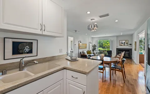 a view of a kitchen island with furniture and wooden floor