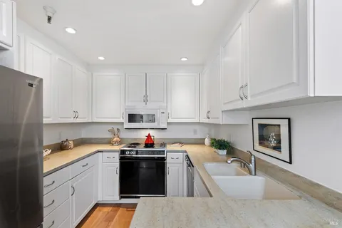 a kitchen with a sink stove and refrigerator