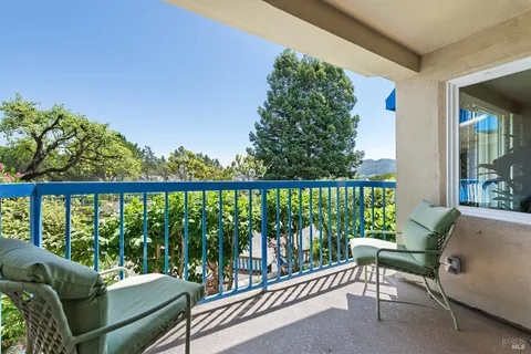 a balcony with chairs in front of it