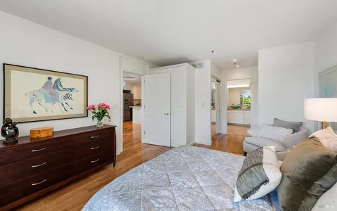 a spacious bedroom with a bed and a dresser