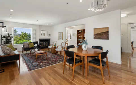 a living room with furniture a table and a fireplace