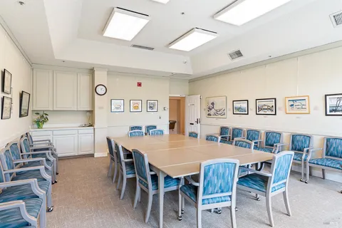 a dining room with a wooden table and chairs