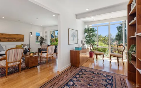 a living room with furniture wooden floor and a rug