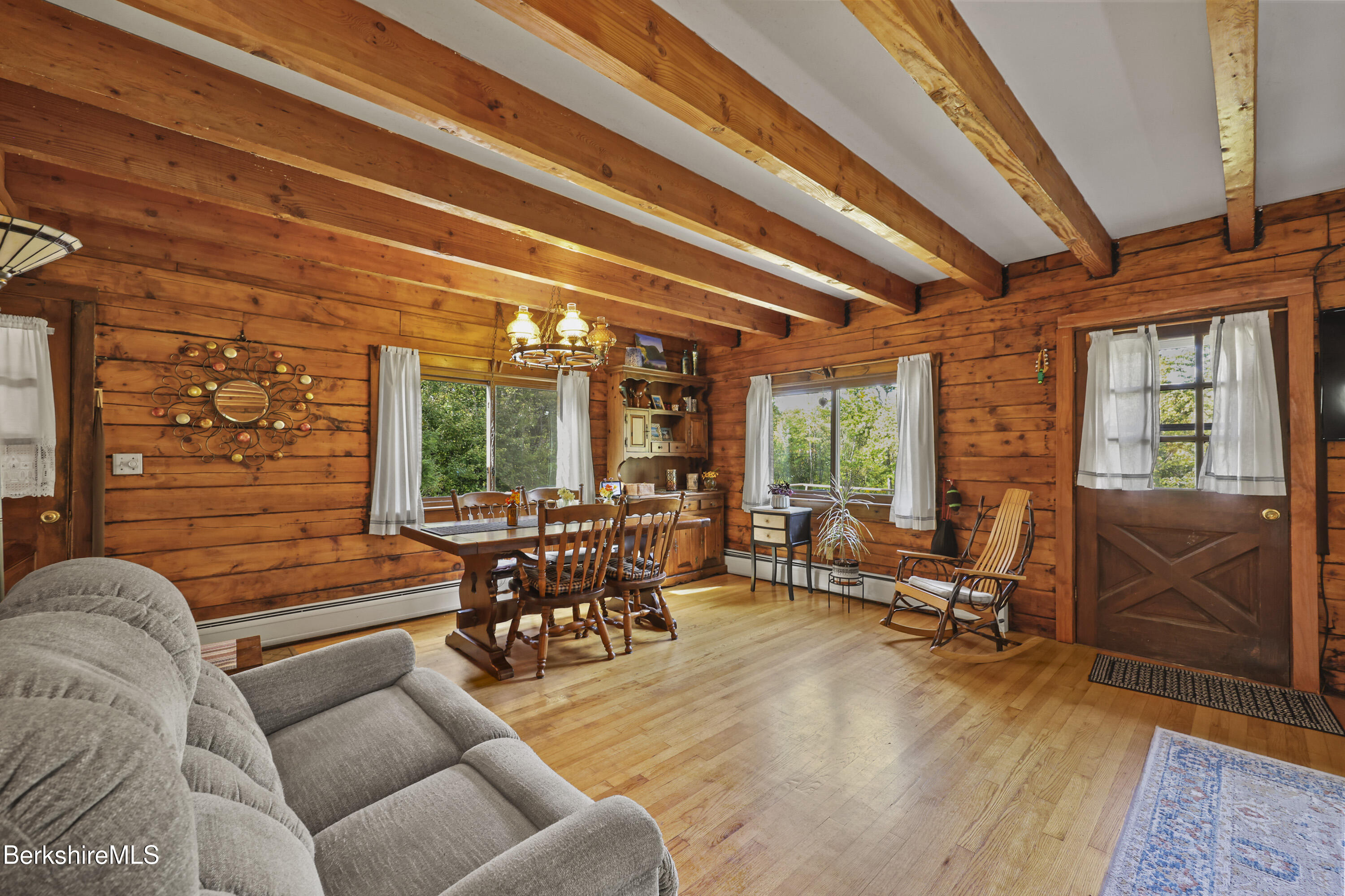 78 East Main Road Peru, MA 01235 - Photo 20 of 56 a living room with furniture a fireplace and large windows