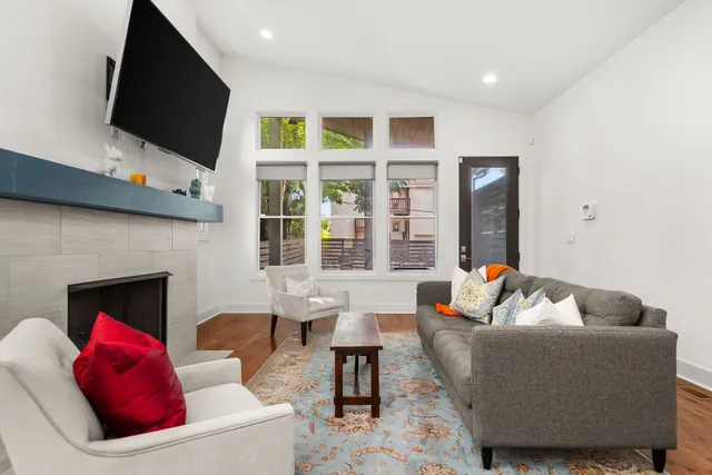 a living room with furniture fireplace and flat screen tv