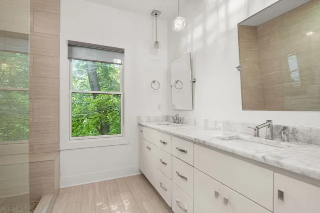 a bathroom with a granite countertop sink mirror and double