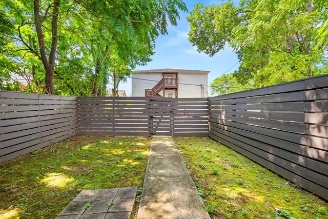 a view of a yard with large trees