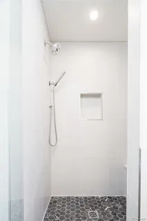 a bathroom with a glass shower door