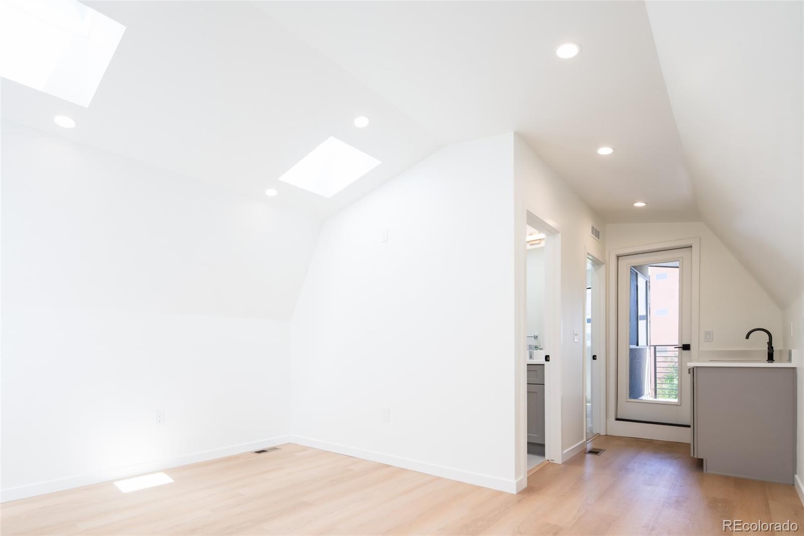 263 South Jackson Street Denver, CO 80209 - Photo 16 of 35 a view of a room with wooden floor and windows