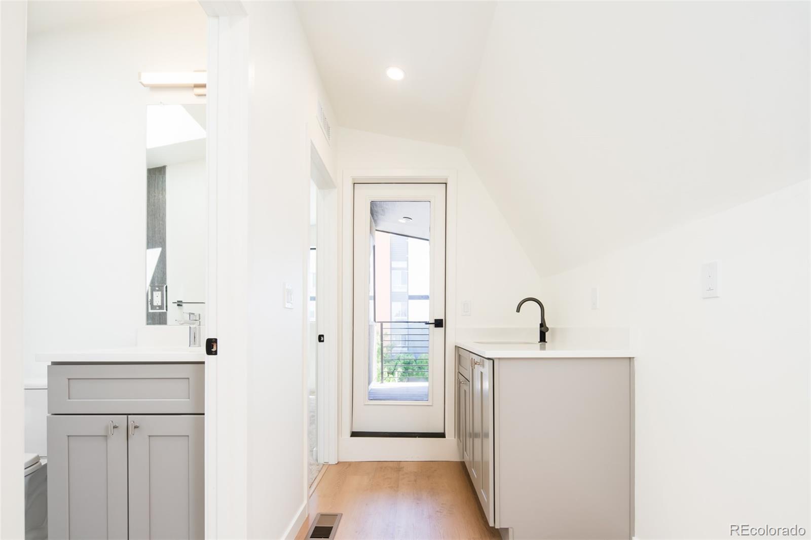 263 South Jackson Street Denver, CO 80209 - Photo 17 of 35 a room with a sink and a mirror
