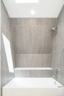 a bathroom with a bathtub and a shower