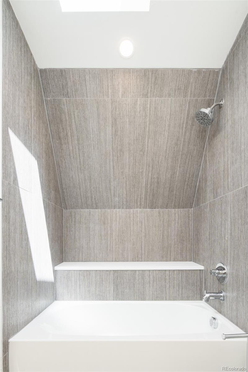 263 South Jackson Street Denver, CO 80209 - Photo 20 of 35 a bathroom with a bathtub and a shower