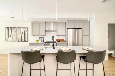 a kitchen with a dining table and chairs