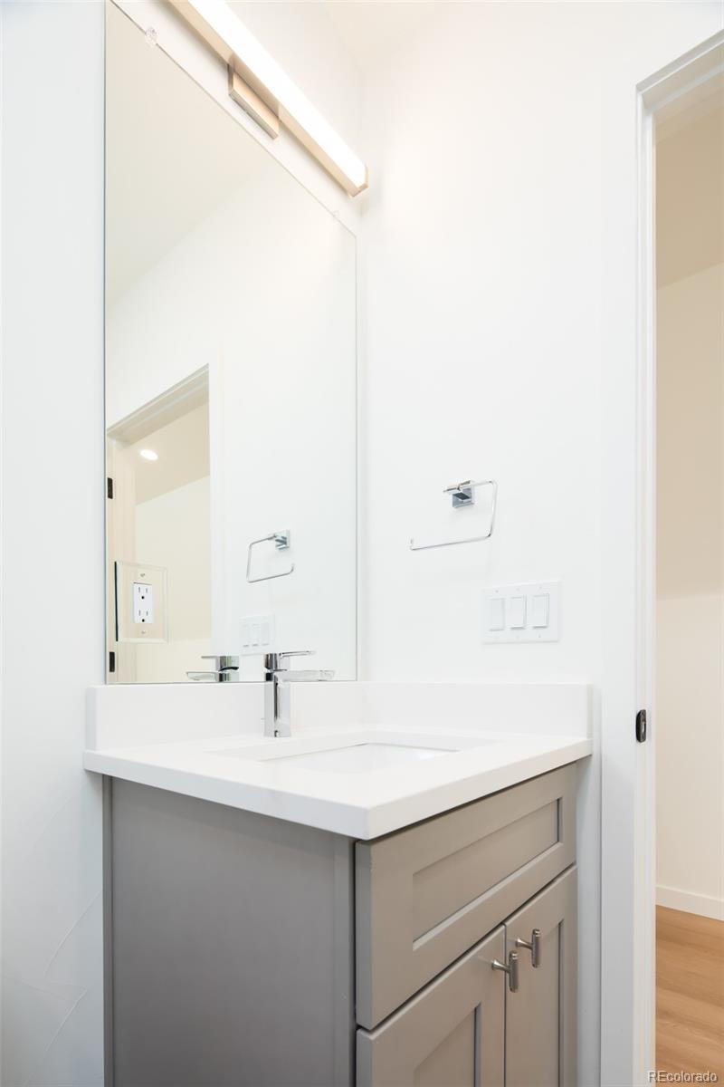 263 South Jackson Street Denver, CO 80209 - Photo 21 of 35 a bathroom with a sink and a mirror
