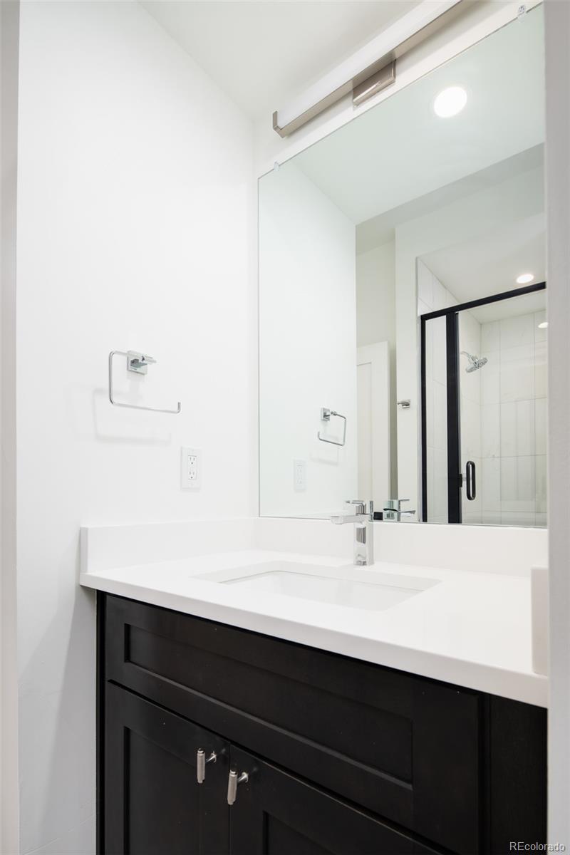 263 South Jackson Street Denver, CO 80209 - Photo 29 of 35 a bathroom with a sink and a mirror