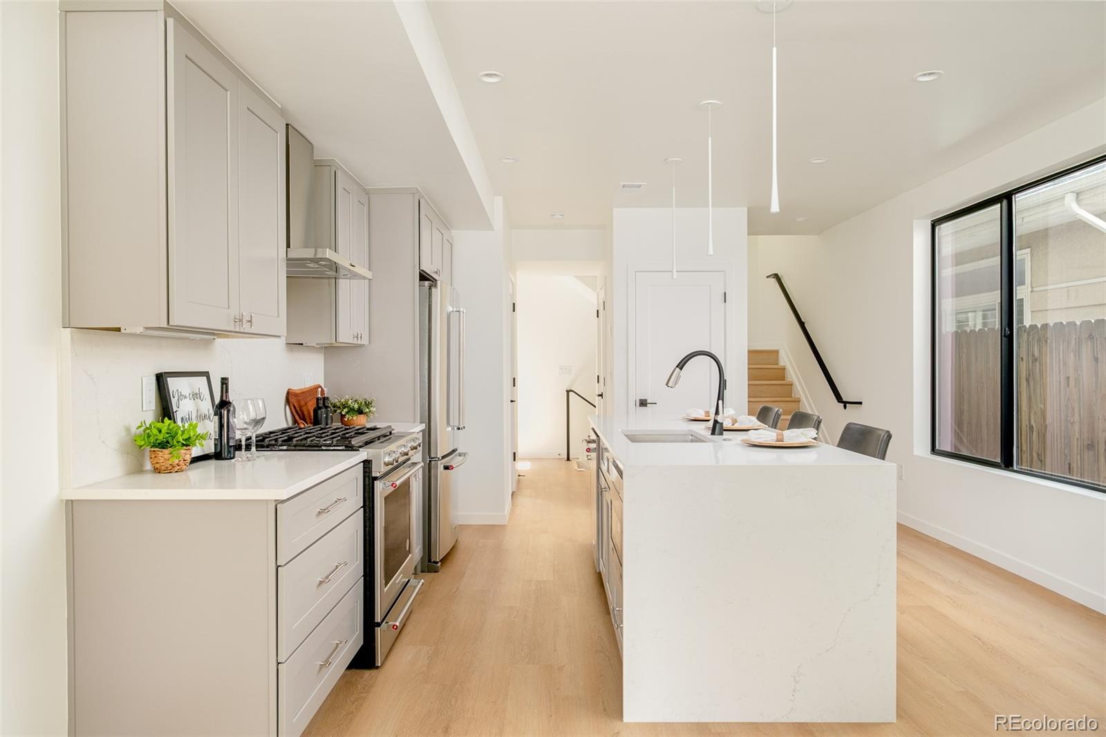 263 South Jackson Street Denver, CO 80209 - Photo 4 of 35 a kitchen with sink a stove and refrigerator