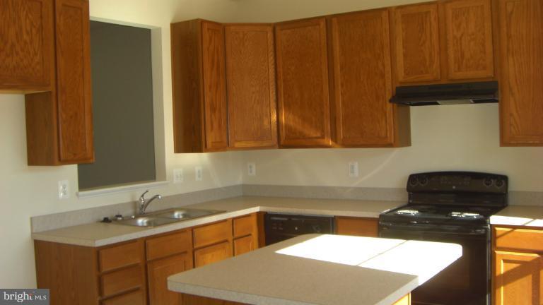 1934 Waltman Road Edgewood, MD 21040 - Photo 1 of 17 a kitchen with a sink and cabinets