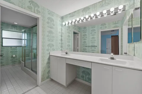 a bathroom with a shower and a glass door