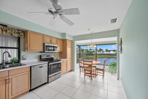 a kitchen with white cabinets stainless steel appliances and sink