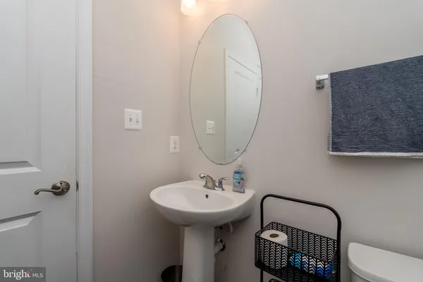 a bathroom with a sink toilet and a mirror