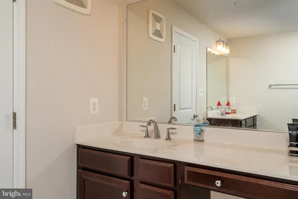 a bathroom with a sink vanity and a mirror